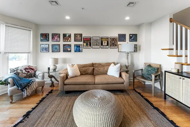 a living room with furniture and a wooden floor