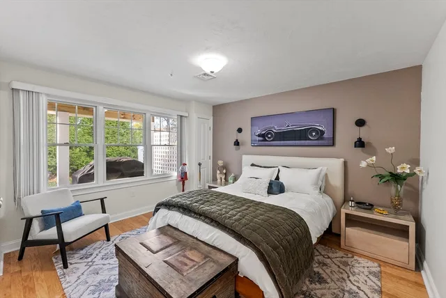 a bedroom with a bed and a large window