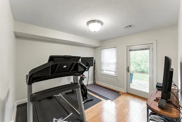 a view of a room with gym equipment and a window