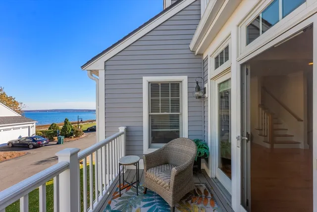 a view of a balcony with chair and wooden floor