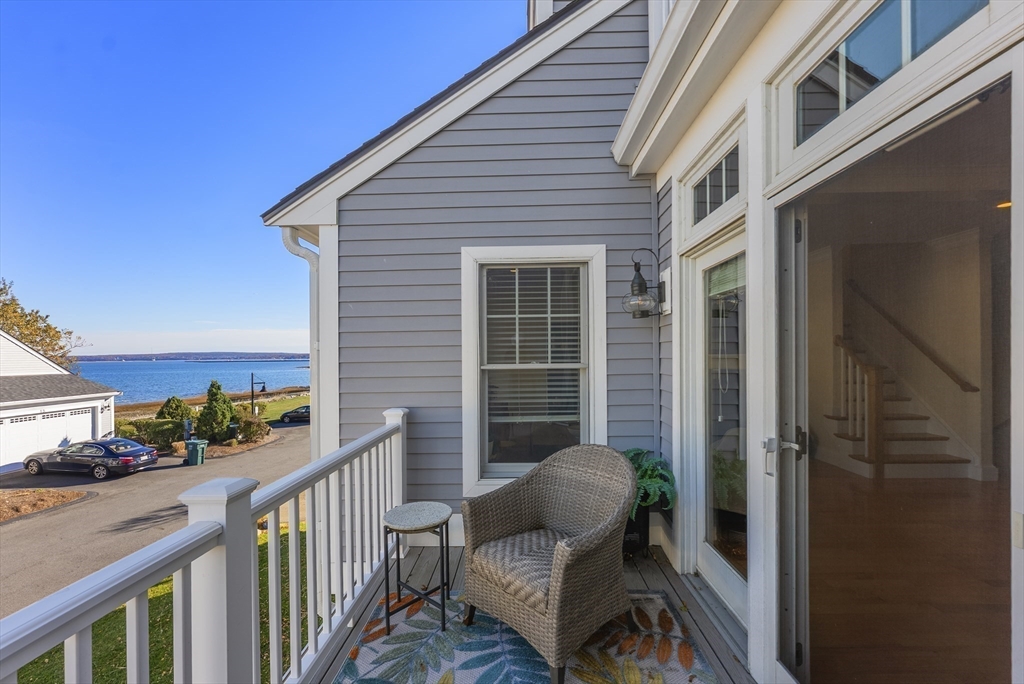 60 Robbins Road, Unit 25 Plymouth, MA 02360 - Photo 22 of 42 a view of a balcony with chair and wooden floor