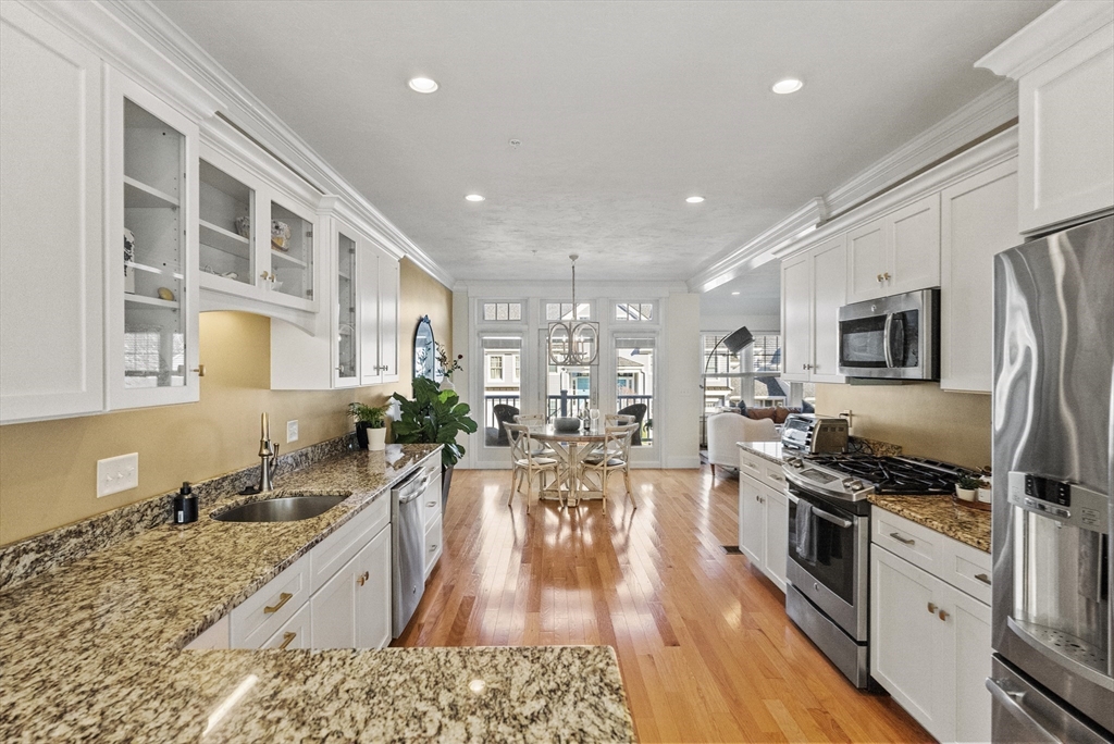 60 Robbins Road, Unit 25 Plymouth, MA 02360 - Photo 27 of 42 a large kitchen with stainless steel appliances granite countertop a lot of counter space and wooden floor