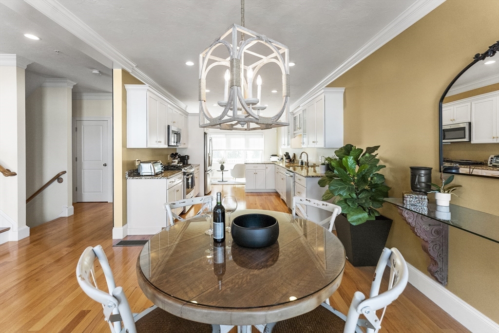 60 Robbins Road, Unit 25 Plymouth, MA 02360 - Photo 28 of 42 a view of a dining room with furniture a chandelier and wooden floor