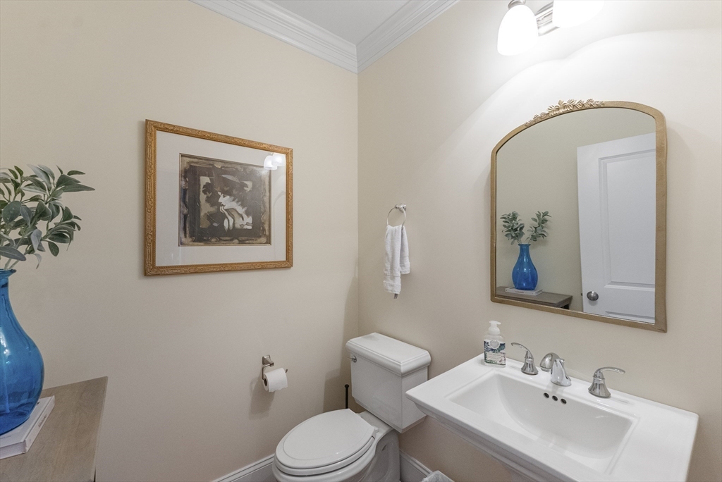 60 Robbins Road, Unit 25 Plymouth, MA 02360 - Photo 34 of 42 a bathroom with a toilet a sink and mirror