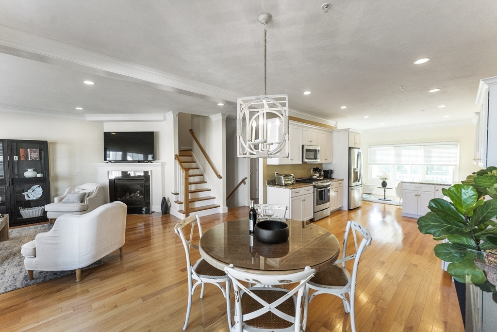60 Robbins Road, Unit 25 Plymouth, MA 02360 - Photo 35 of 42 a view of a dining room and livingroom with furniture wooden floor a chandelier