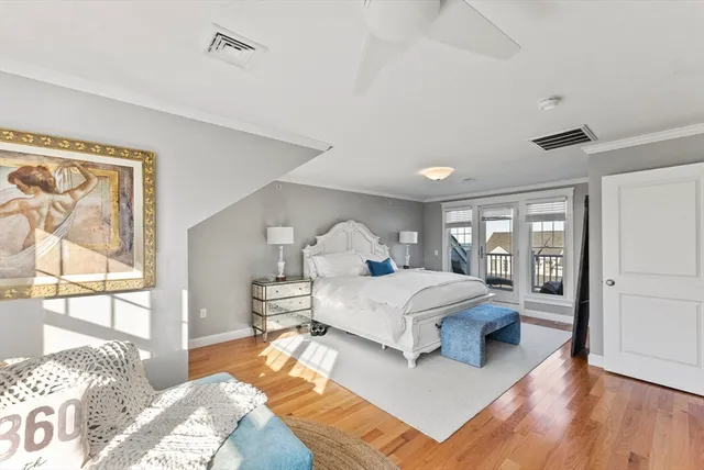 a bedroom with a large bed and a window