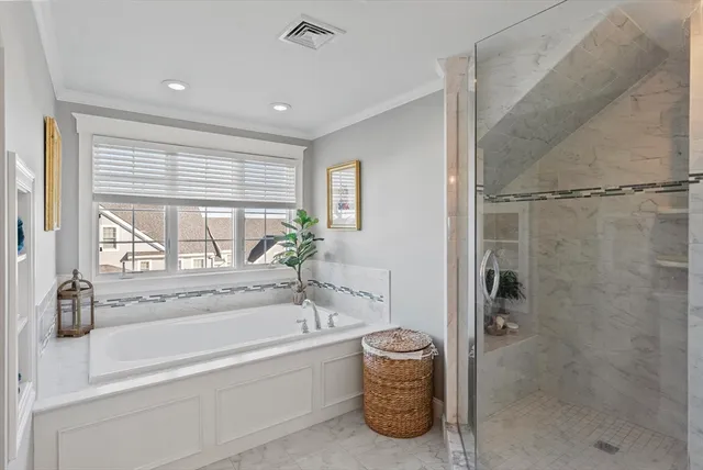 a spacious bathroom with a tub shower and a sink