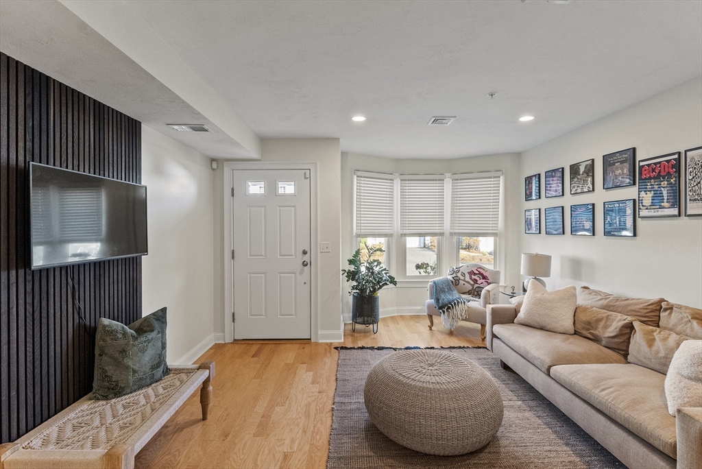 60 Robbins Road, Unit 25 Plymouth, MA 02360 - Photo 9 of 42 a living room with furniture and a flat screen tv