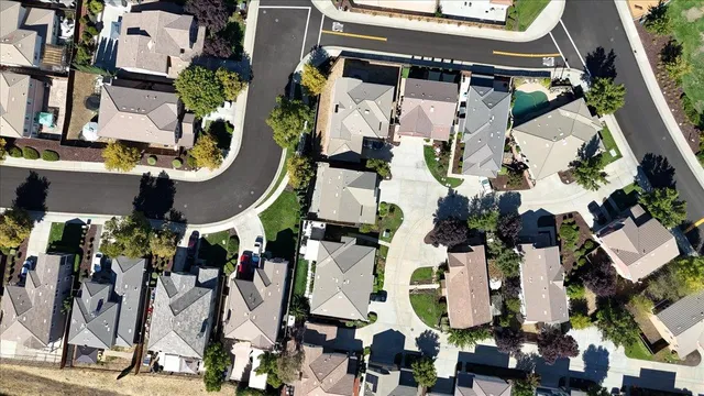 an aerial view of residential houses with outdoor space