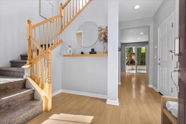 a view of entryway and hall with wooden floor