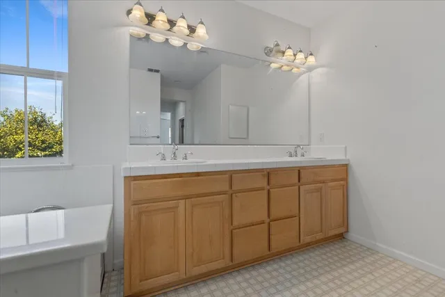 a bathroom with a sink vanity and a mirror