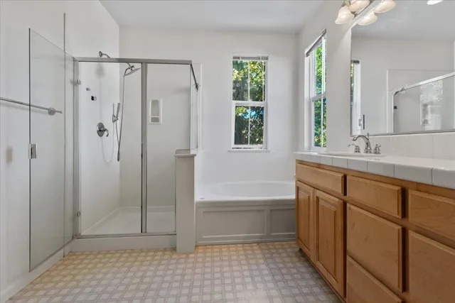 a bathroom with a shower a sink and a bathtub