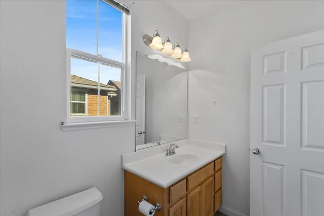 a bathroom with a sink vanity and a mirror