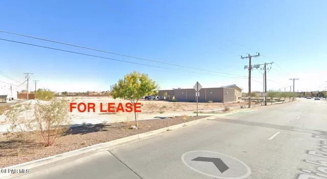 a street sign on a sidewalk next to road