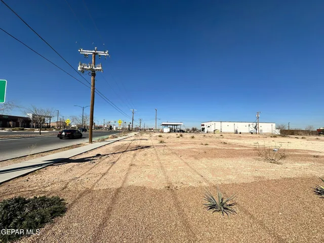 a view of a swimming pool and a lot of car parked