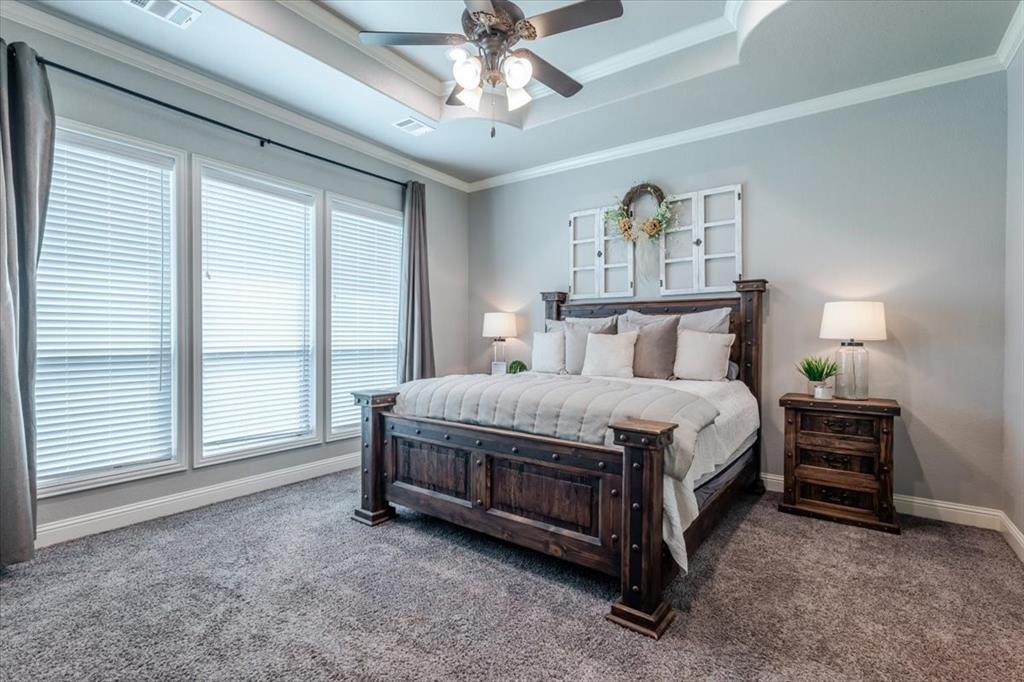 104 Lagrange Court Weatherford, TX 76088 - Photo 11 of 25 a spacious bedroom with a bed painting and a large window