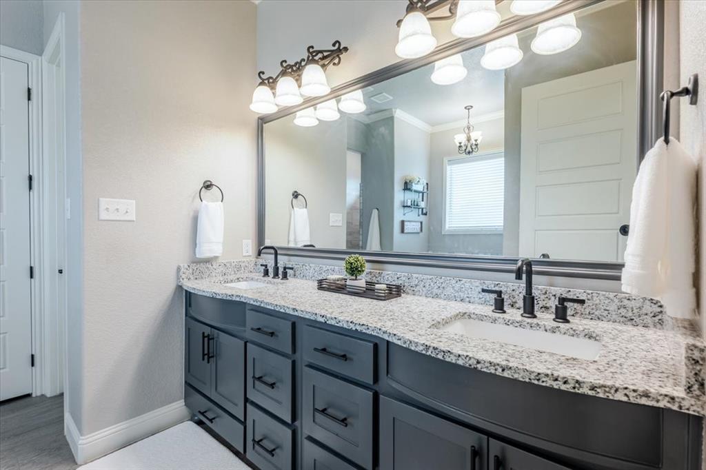 104 Lagrange Court Weatherford, TX 76088 - Photo 15 of 25 a bathroom with double vanity sinks and a mirror