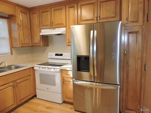 a kitchen with cabinets and stainless steel appliances