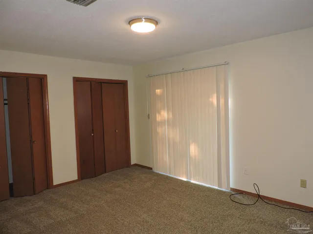 an empty room with closet area