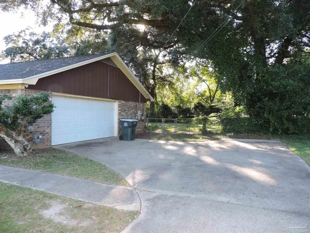 a view of a house with a yard and garage