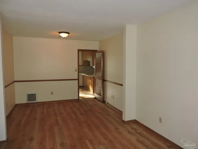 a view of a room with wooden floor