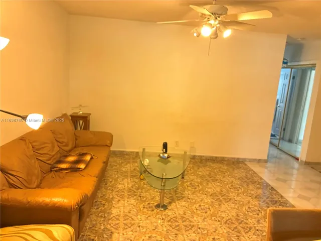 a living room with a couch and wooden floor