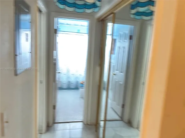 a view of a bathroom from a hallway