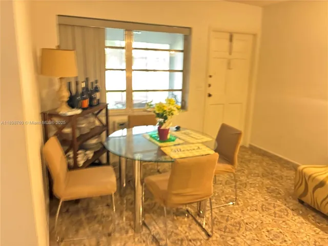 a view of a dining room with furniture and a window