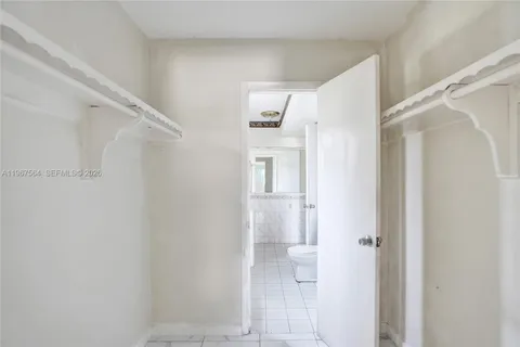 a bathroom with a shower and a glass door