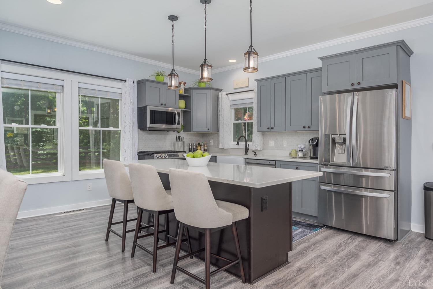 51 Hughes Road Farmville, VA 23901 - Photo 13 of 63 a kitchen with stainless steel appliances granite countertop a dining table chairs refrigerator and microwave