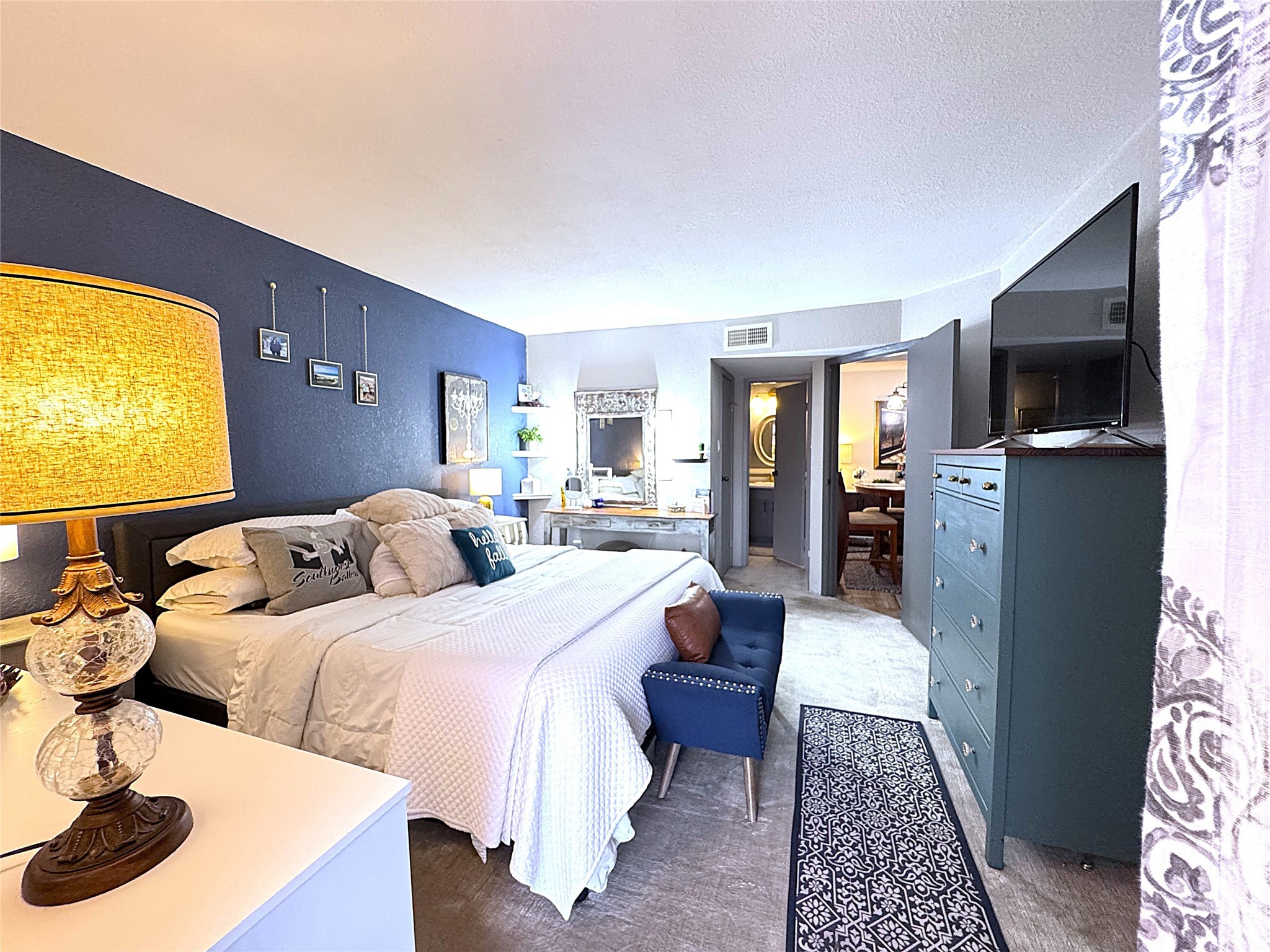 10110 Forum W Drive, Unit 421 Houston, TX 77036 - Photo 4 of 27 a bedroom with a bed and wooden floor