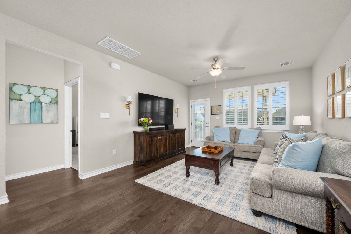 280 Pepperbark Loop Buda, TX 78610 - Photo 15 of 38 Living area featuring dark wood-style floors and ceiling fan