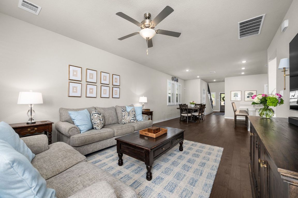 280 Pepperbark Loop Buda, TX 78610 - Photo 17 of 38 Living room with dark wood-type flooring, a ceiling fan, and recessed lighting