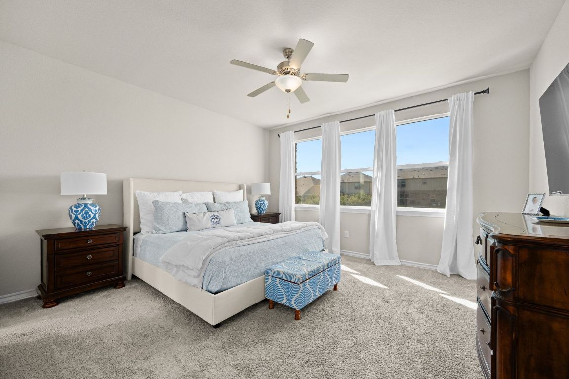 280 Pepperbark Loop Buda, TX 78610 - Photo 18 of 38 Bedroom with light colored carpet and a ceiling fan