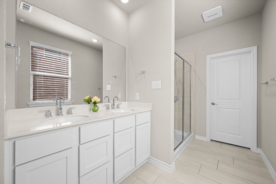 280 Pepperbark Loop Buda, TX 78610 - Photo 19 of 38 Bathroom with a stall shower and double vanity