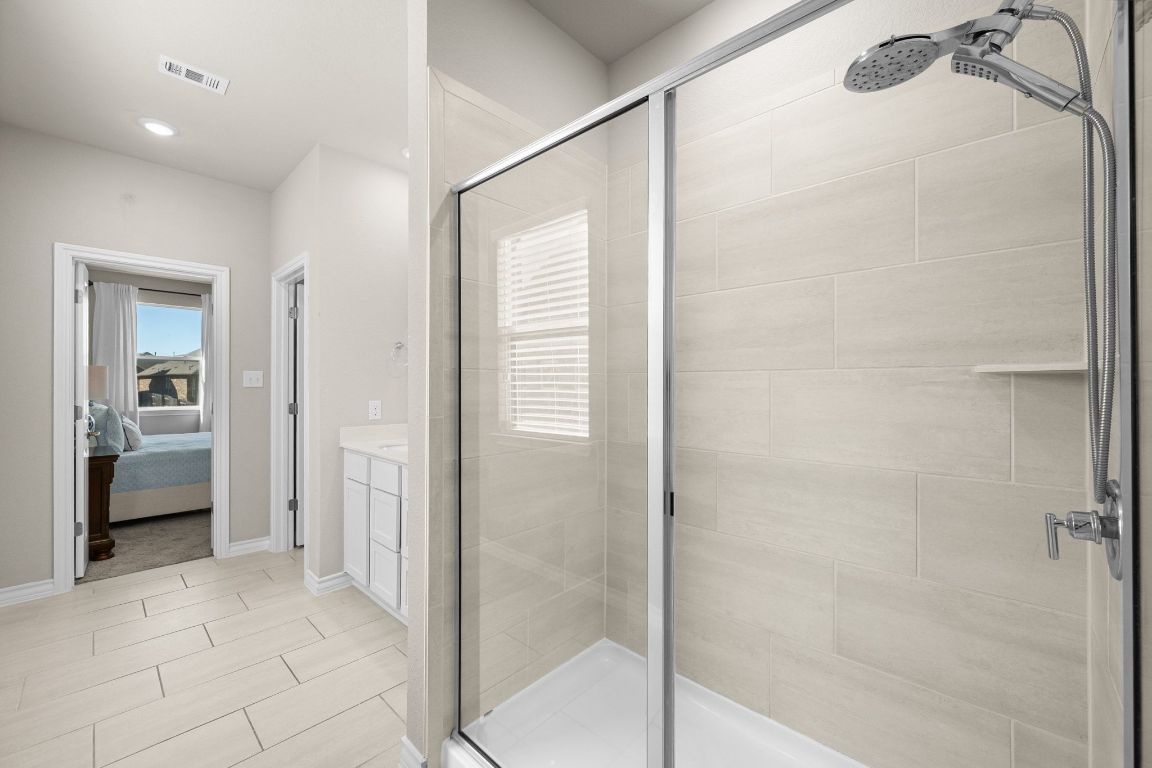 280 Pepperbark Loop Buda, TX 78610 - Photo 21 of 38 Full bath featuring vanity, a stall shower, and connected bathroom