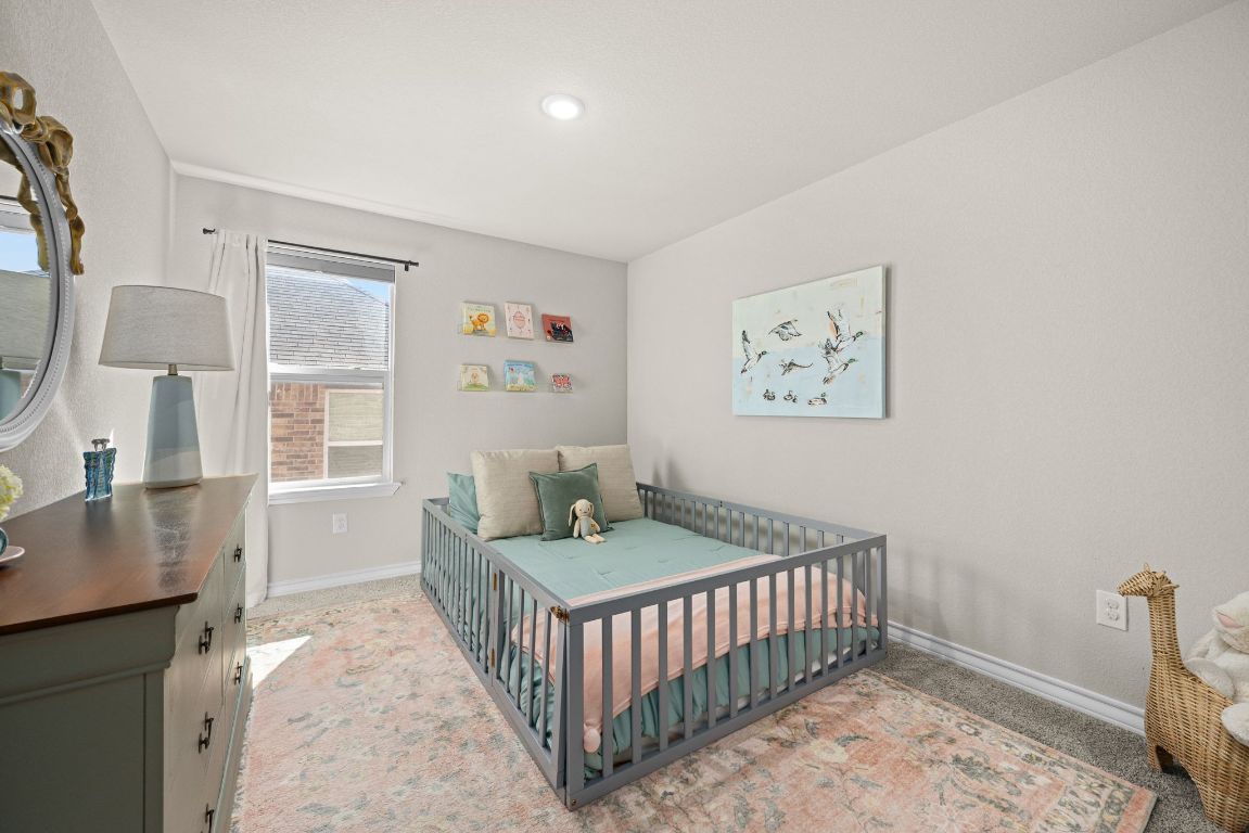 280 Pepperbark Loop Buda, TX 78610 - Photo 25 of 38 Bedroom featuring baseboards and light carpet