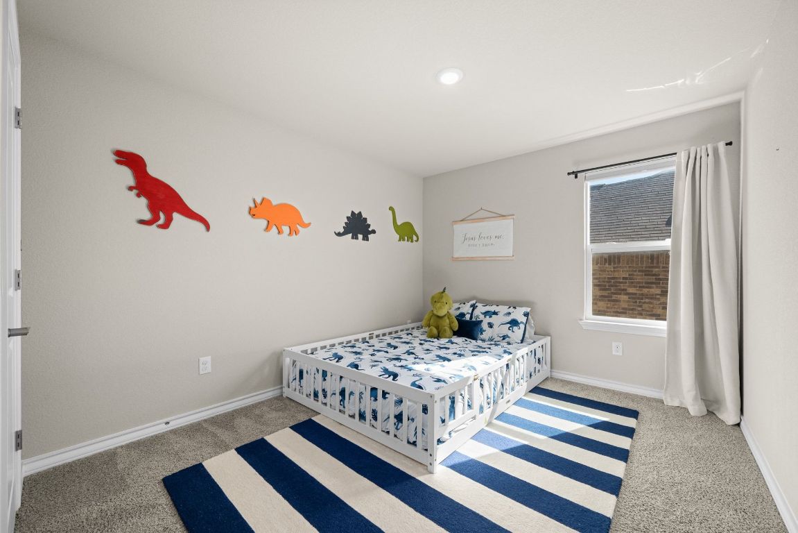 280 Pepperbark Loop Buda, TX 78610 - Photo 27 of 38 Carpeted bedroom featuring baseboards