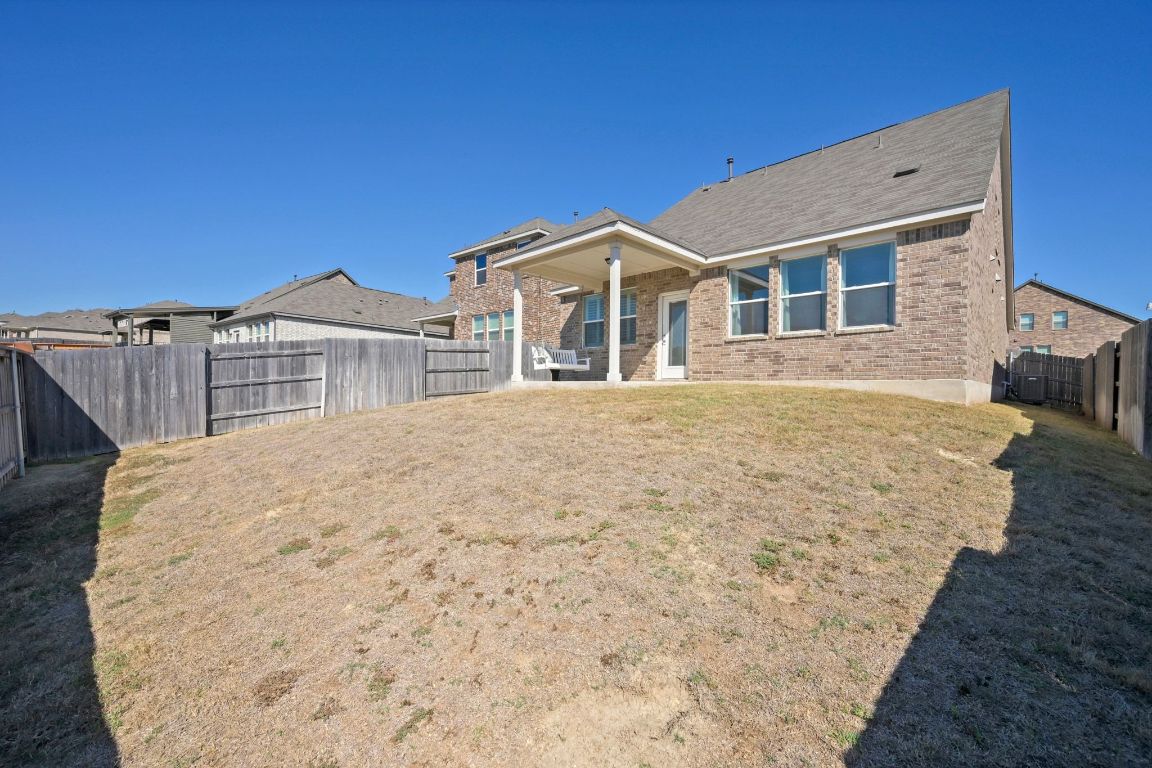280 Pepperbark Loop Buda, TX 78610 - Photo 29 of 38 Back of house with a patio, brick siding, and a fenced backyard