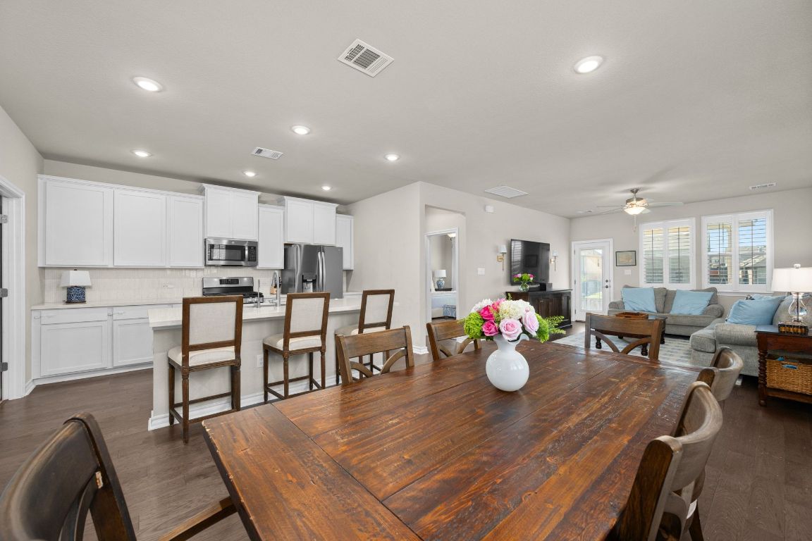 280 Pepperbark Loop Buda, TX 78610 - Photo 7 of 38 Dining space featuring dark wood-style floors, a ceiling fan, and recessed lighting