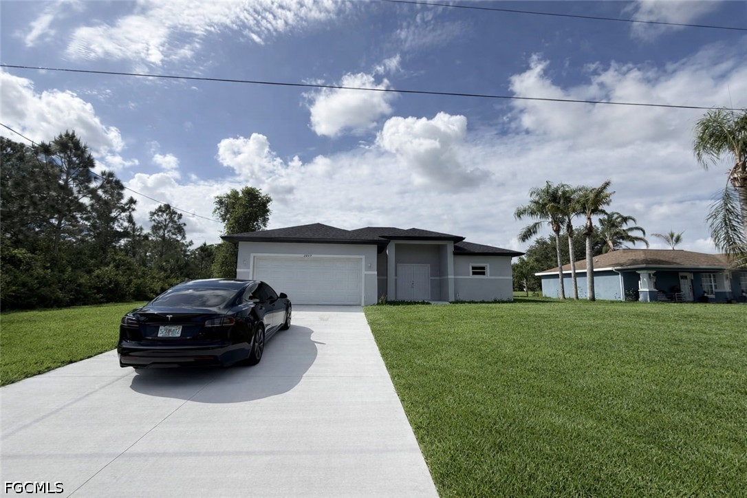 2809 Darlene Place Lehigh Acres, FL 33971 - Photo 1 of 26 a house view with a garden space