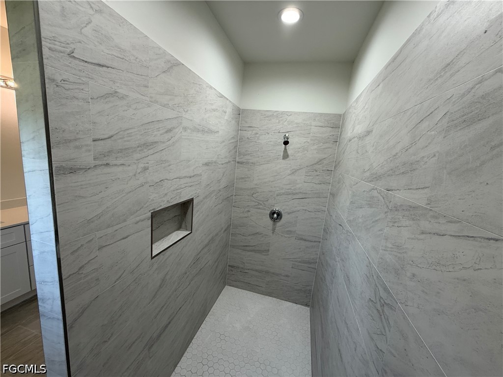 2809 Darlene Place Lehigh Acres, FL 33971 - Photo 15 of 26 a bathroom with a shower and a sink