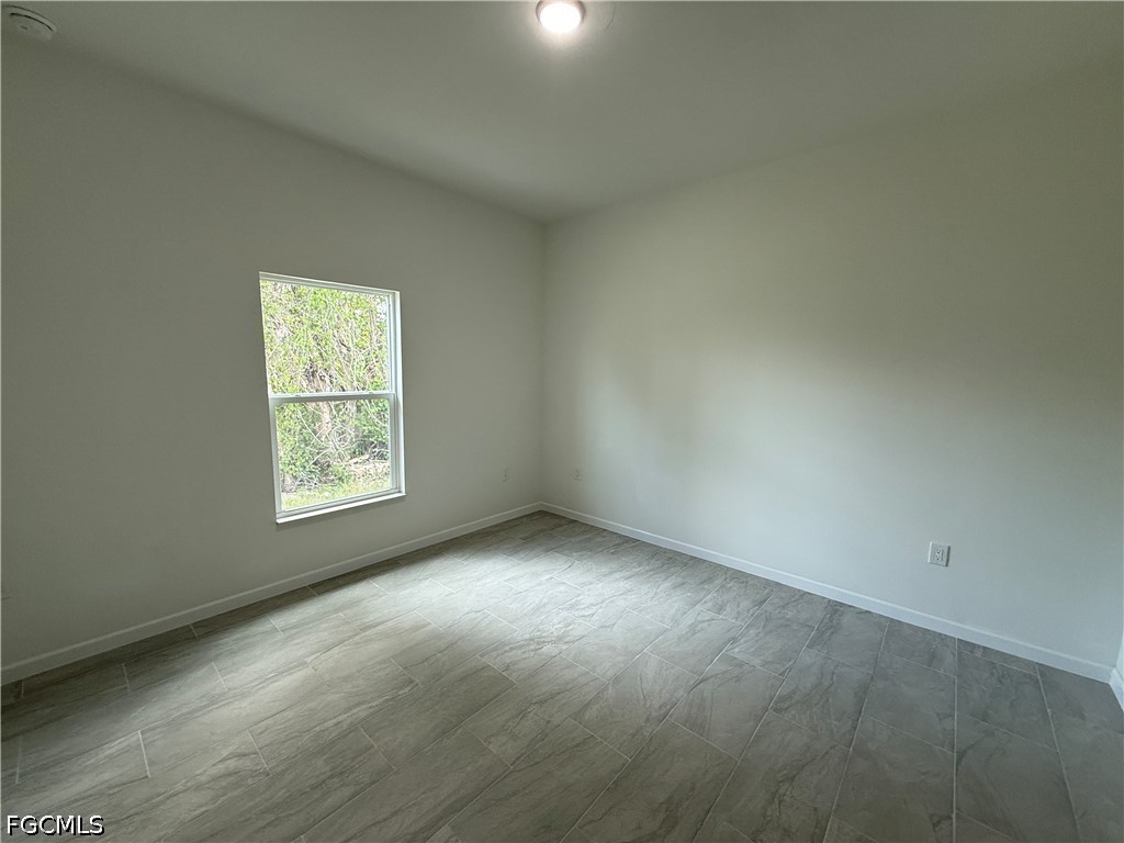 2809 Darlene Place Lehigh Acres, FL 33971 - Photo 16 of 26 an empty room with a window