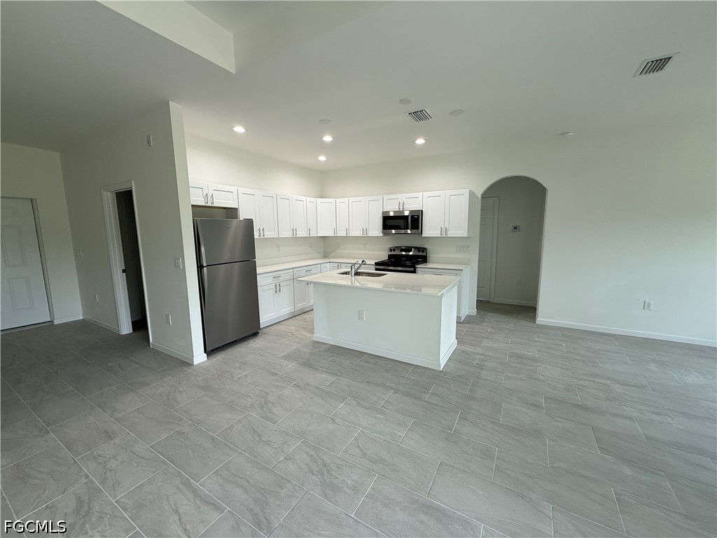 2809 Darlene Place Lehigh Acres, FL 33971 - Photo 5 of 26 a view of kitchen with stainless steel appliances granite countertop a refrigerator sink and white cabinets