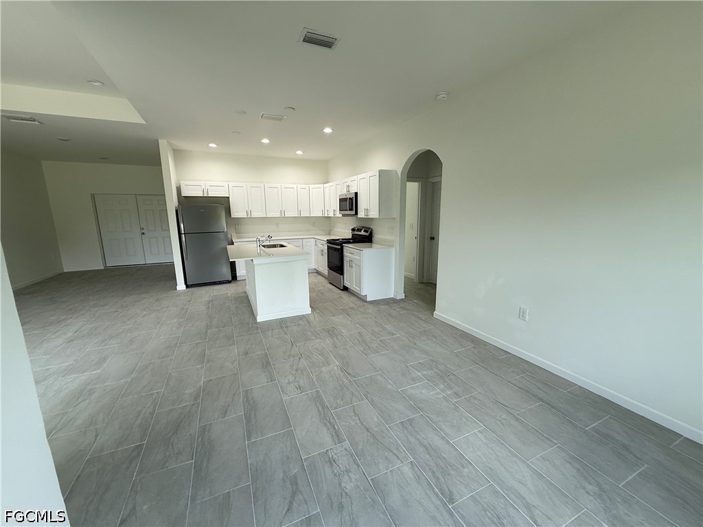 2809 Darlene Place Lehigh Acres, FL 33971 - Photo 6 of 26 a view of a kitchen with refrigerator and microwave