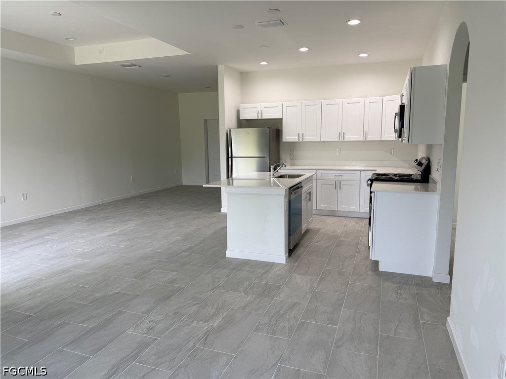 2809 Darlene Place Lehigh Acres, FL 33971 - Photo 8 of 26 a kitchen with a sink stove and refrigerator