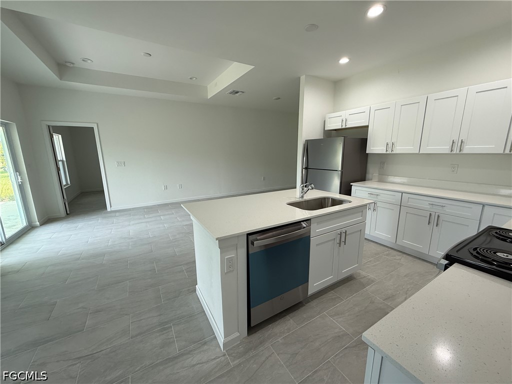 2809 Darlene Place Lehigh Acres, FL 33971 - Photo 9 of 26 a kitchen with stainless steel appliances granite countertop a stove a sink and a refrigerator