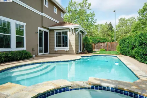 a swimming pool with outdoor seating and yard