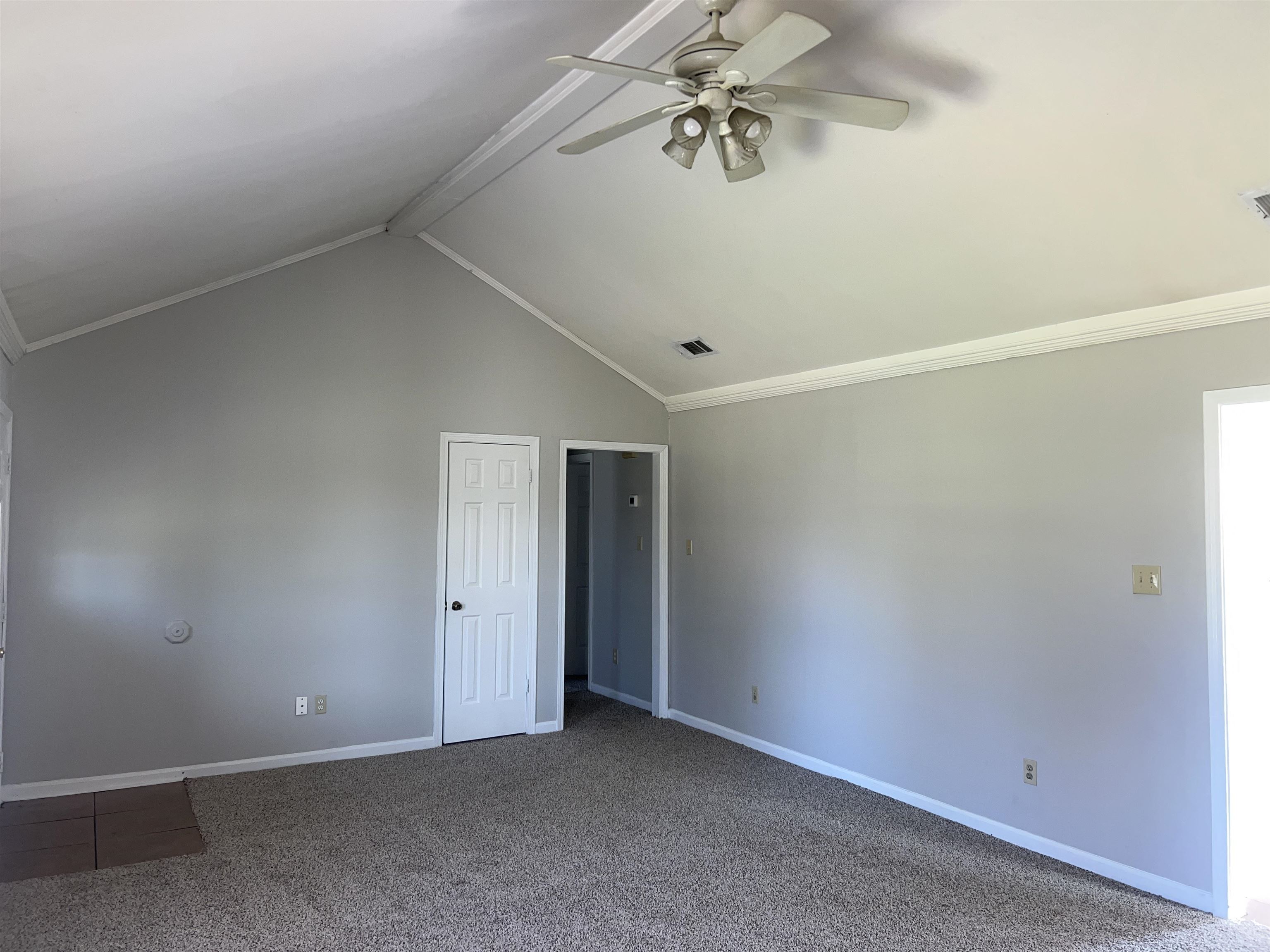 4609 Crestfield Road Millington, TN 38053 - Photo 4 of 8 Carpeted spare room featuring vaulted ceiling with beams, ceiling fan, and ornamental molding