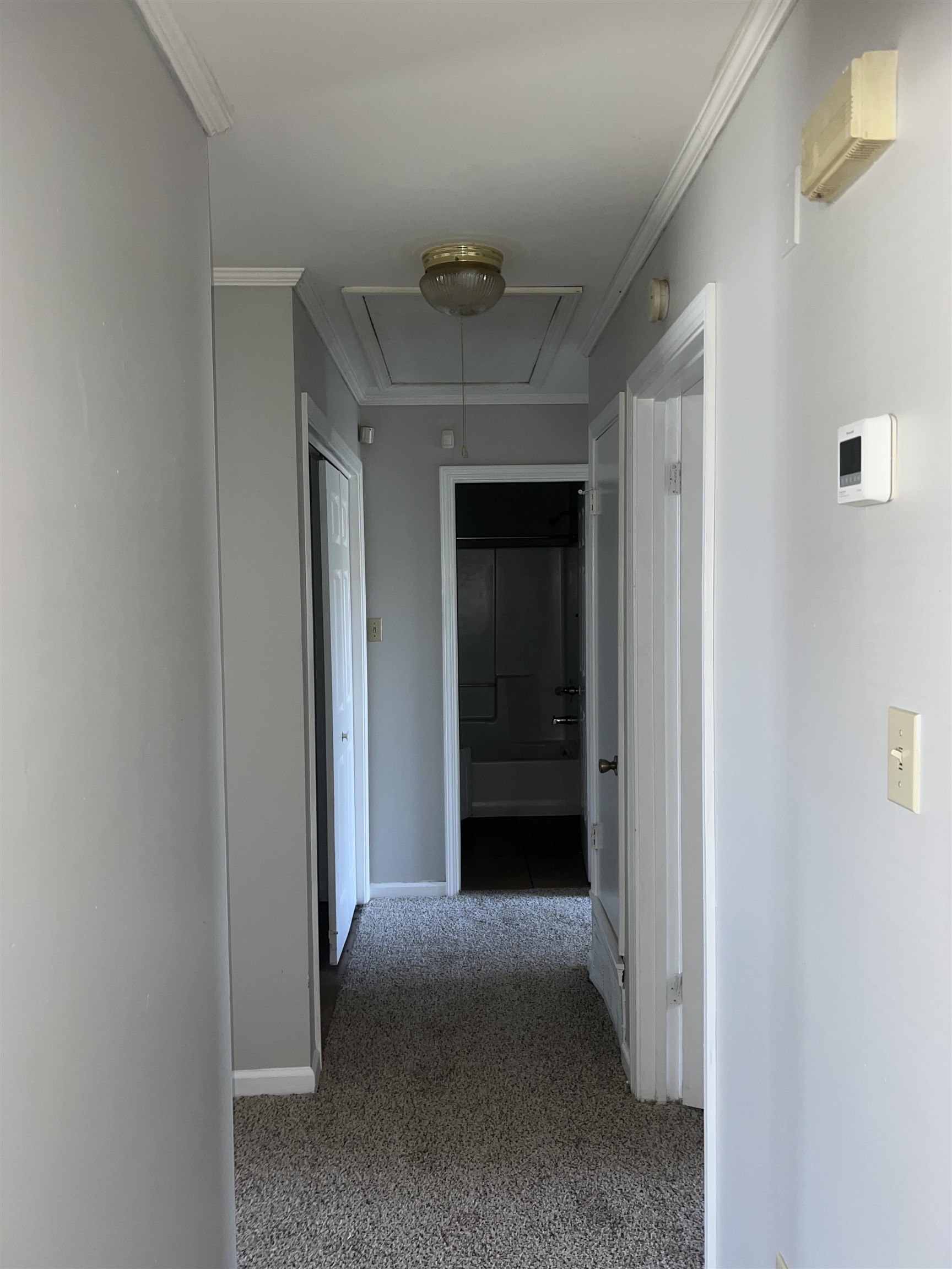 4609 Crestfield Road Millington, TN 38053 - Photo 6 of 8 Hallway featuring dark colored carpet and crown molding